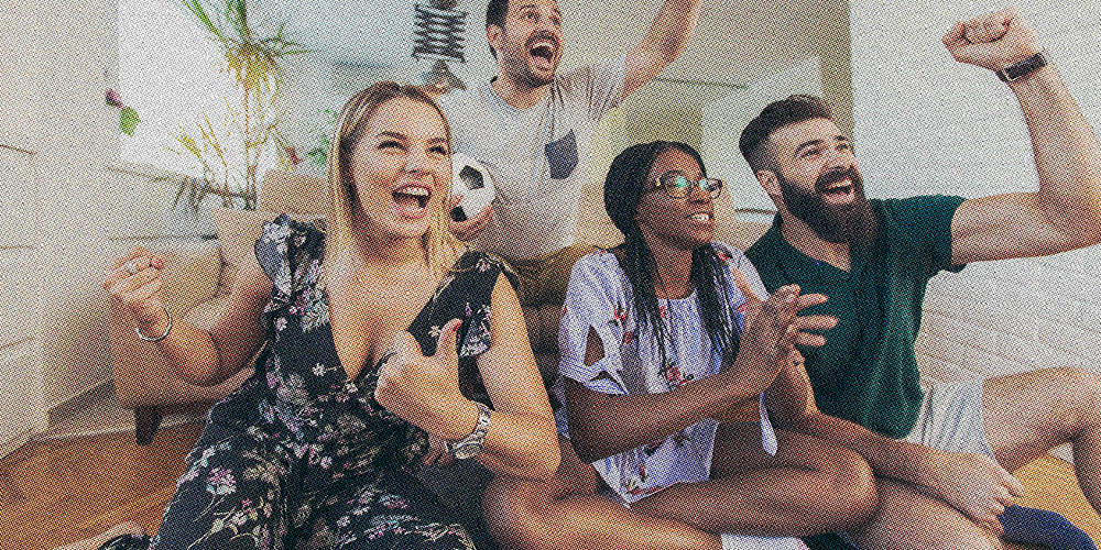 friends watch football together and cheer
