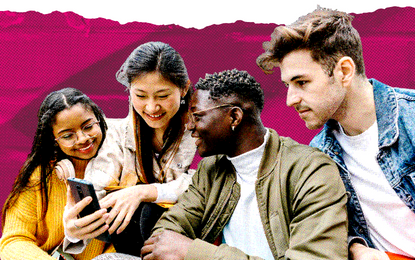 A group of four people looking at a cell phone in front of a graphic designed magenta background